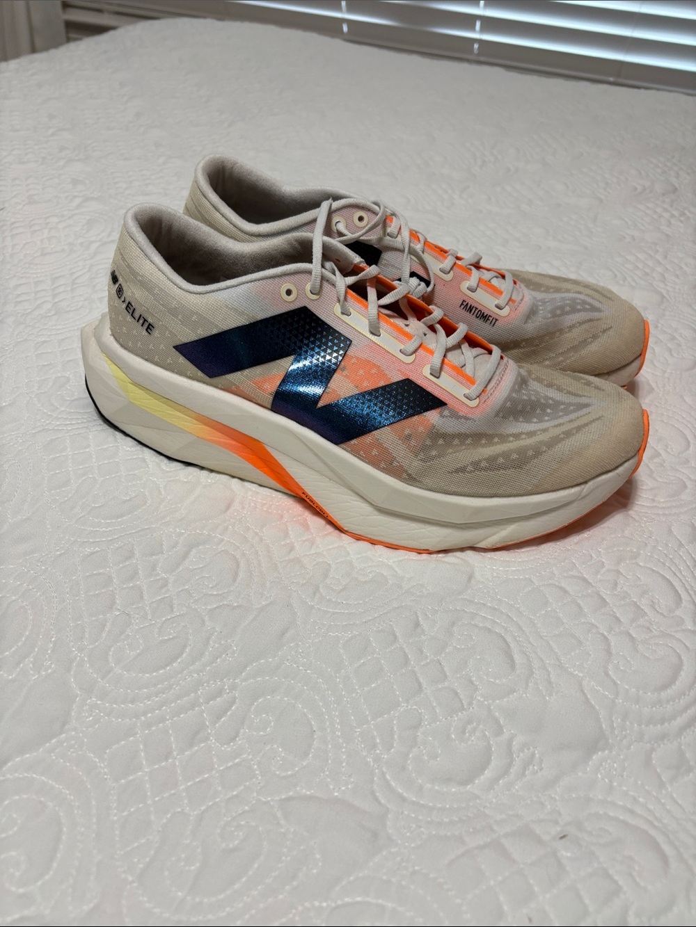 New Balance Beige Running Shoes with Blue and Orange Accents
